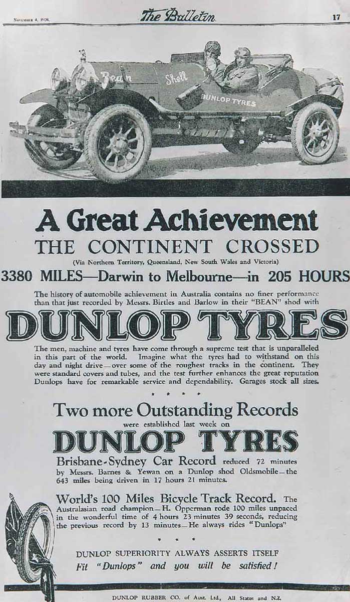 Black and white advertisement with an image of an two men sitting in an open-topped car. Below is printed text, some of which reads: 'A Great Achievement / THE CONTINENT CROSSED / 3380 MILES - Darwin to Melbourne - in 205 hours / DUNLOP TYRES'. - click to view larger image