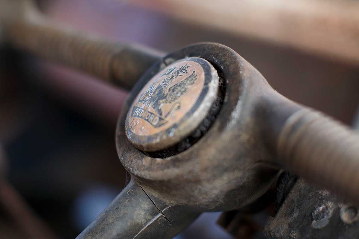 A circular 'Bedford logo' at the centre top of a section of steering wheel. - click to view larger image