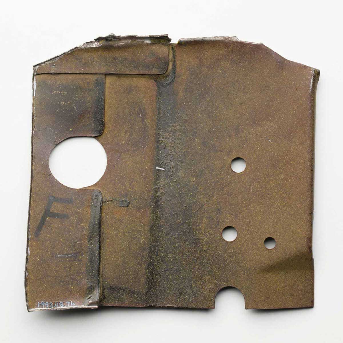 Piece of khaki metal dashboard, with one section magnified for display. - click to view larger image