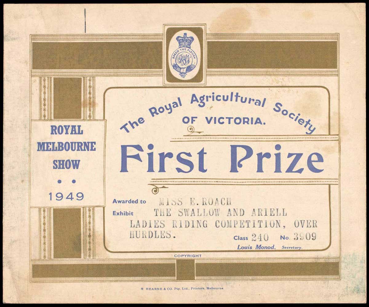 A rectangular certificate that is cream in colour with gold decorations and blue and black text. In the centre, top of the certificate is the Royal Agricultural Society of Victoria badge, appearing as a fastened belt beneath a crown. Around the length of the belt is the text 