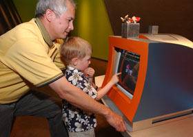A man and child looking at a computer screen.