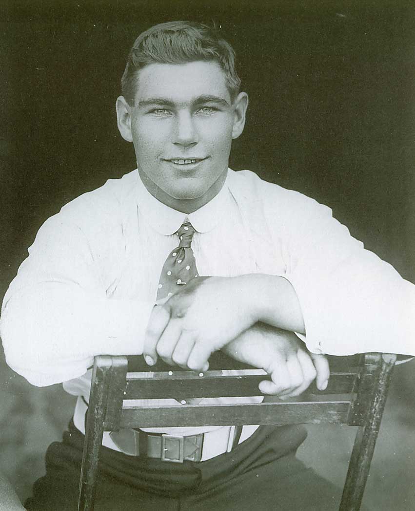 Black and white portrait of Les Darcy that depicts him sitting on a stool. - click to view larger image