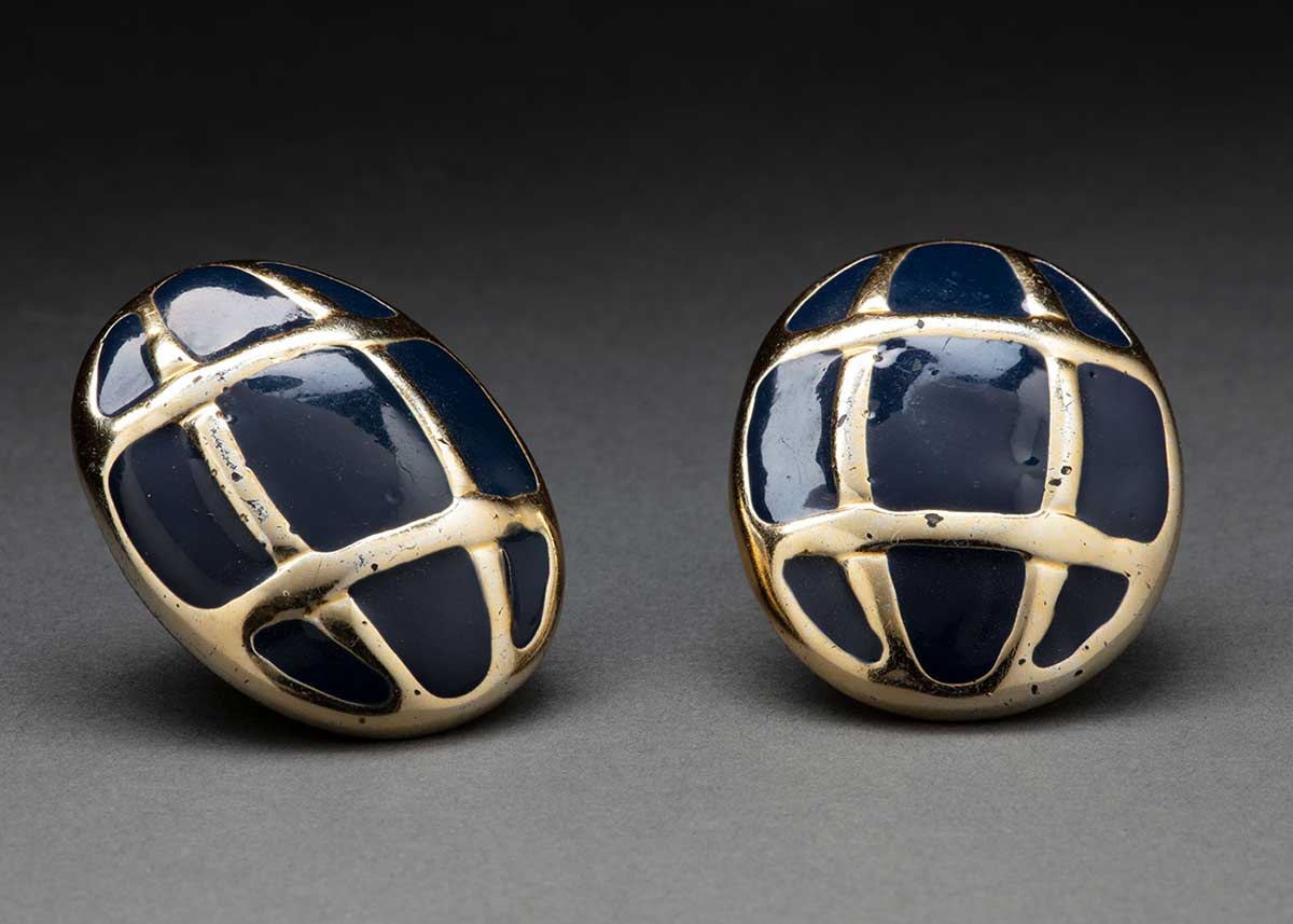 A pair of navy and gold earrings.