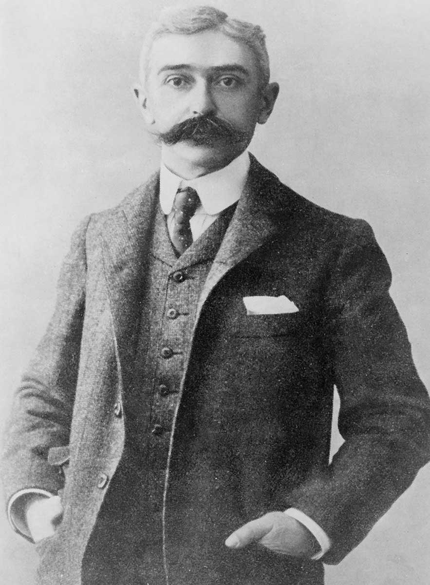 half length portrait of Baron Pierre de Coubertin, standing facing front - click to view larger image