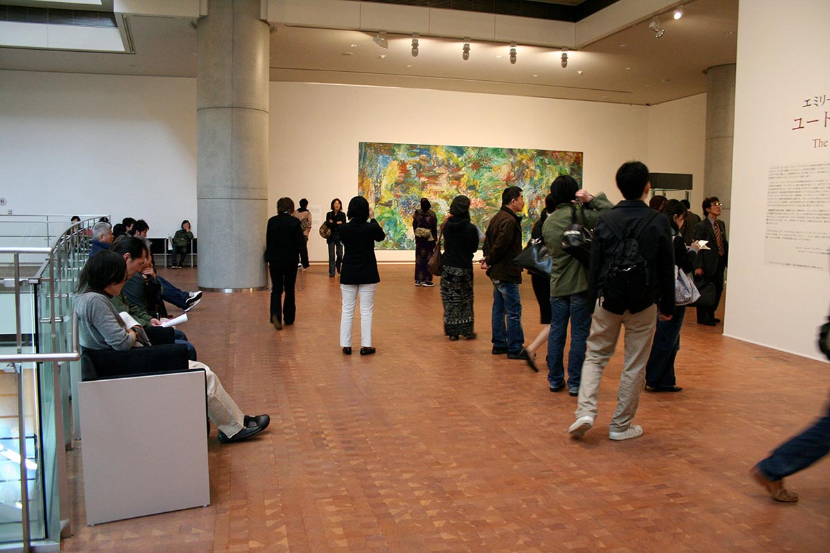 Visitors in an exhibition space viewing art works. - click to view larger image