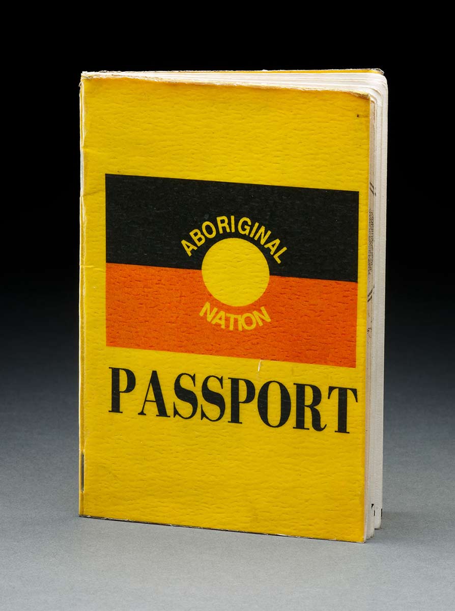 A yellow passport with a cover showing the Aboriginal flag with the text 'ABORIGINAL NATION PASSPORT'. - click to view larger image