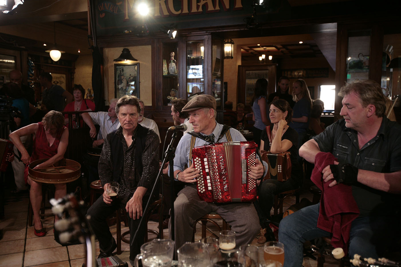 Musicians, Irish dancers and film crew on set in a pub. - click to view larger image