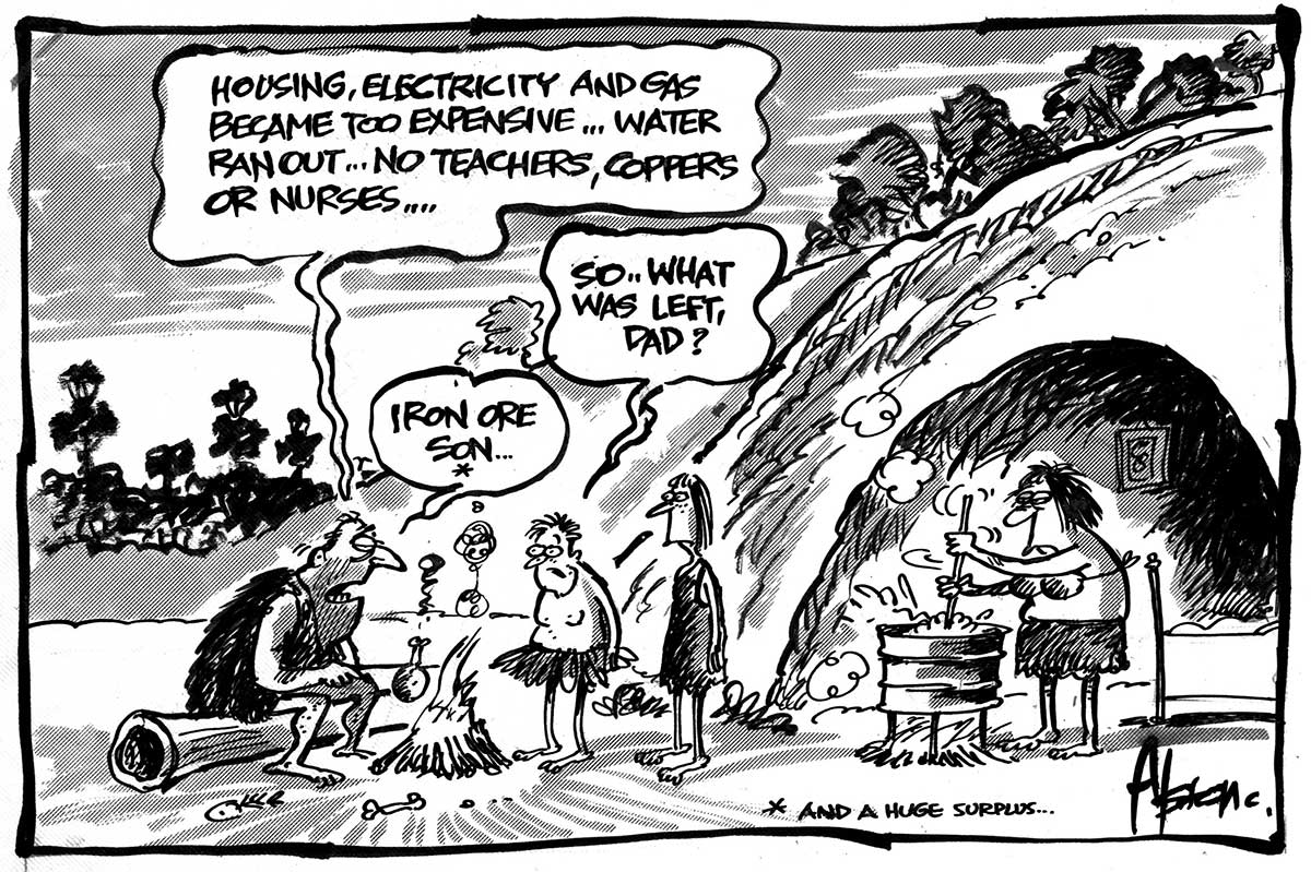 A father, mother and their son and daughter are outside a cave. All wear primitive clothing made from grass and animal fur. The father sits at the left on a log roasting a chicken leg over a fire. The mother is at the right stirring something in a cooking pot made from a fuel drum. The son and daughter face the father, who is saying 'Housing, electricity and gas became too expensive...water ran out...no teachers, coppers or nurses...' The son is saying 'So...what was left, Dad?' The father replies 'Iron ore son...' - click to view larger image