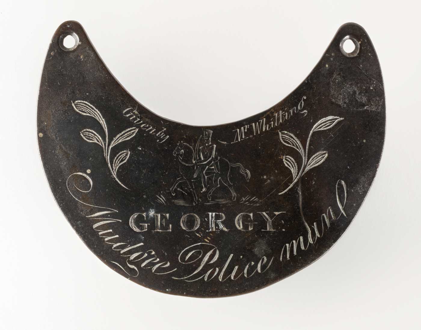 Engraved breastplate with an image of a mounted police man. - click to view larger image