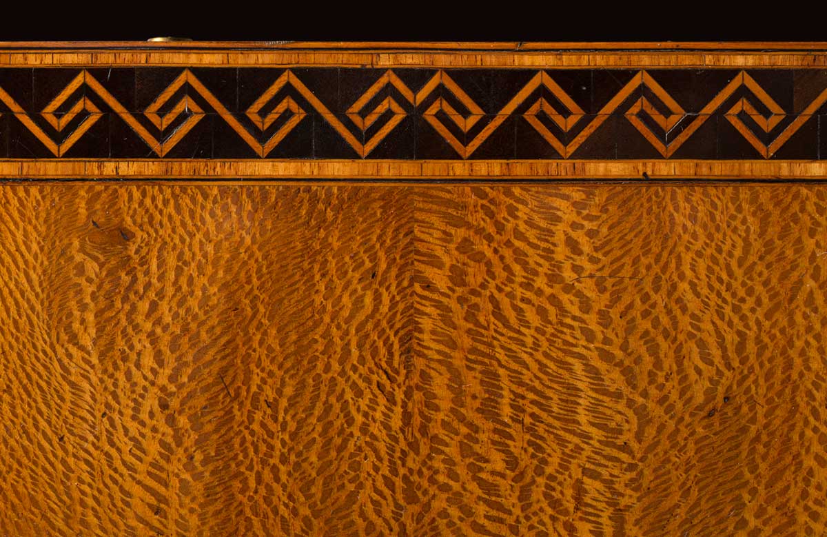 Contrasting timber in a geometric pattern, on a timber tabletop.