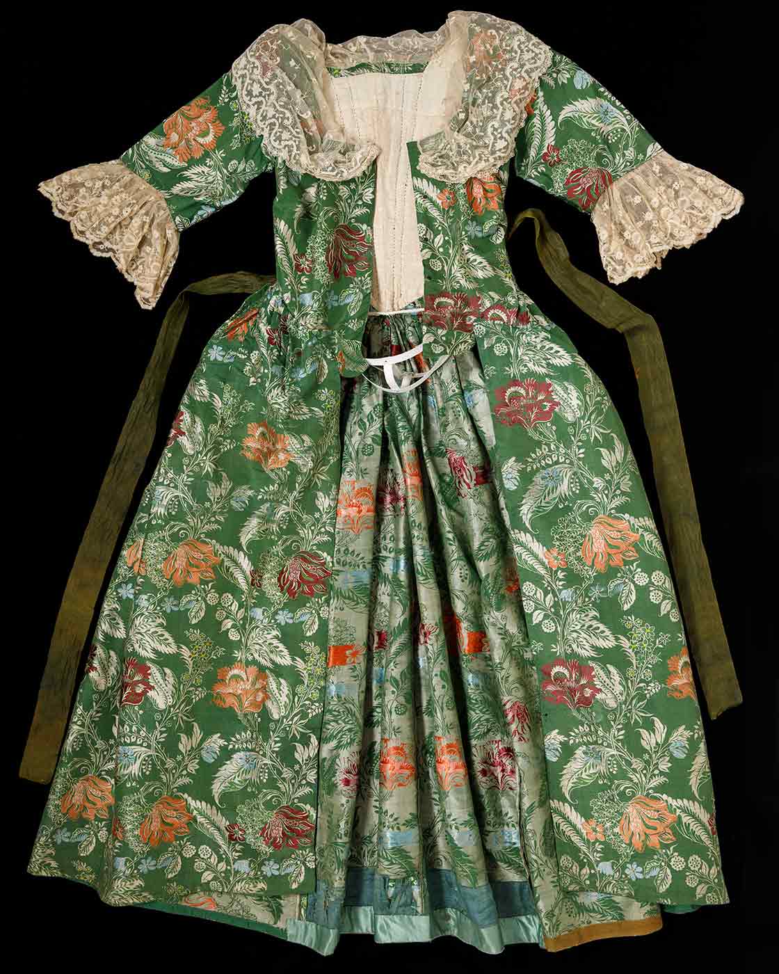 Green and floral brocade open-front gown with lace trim.