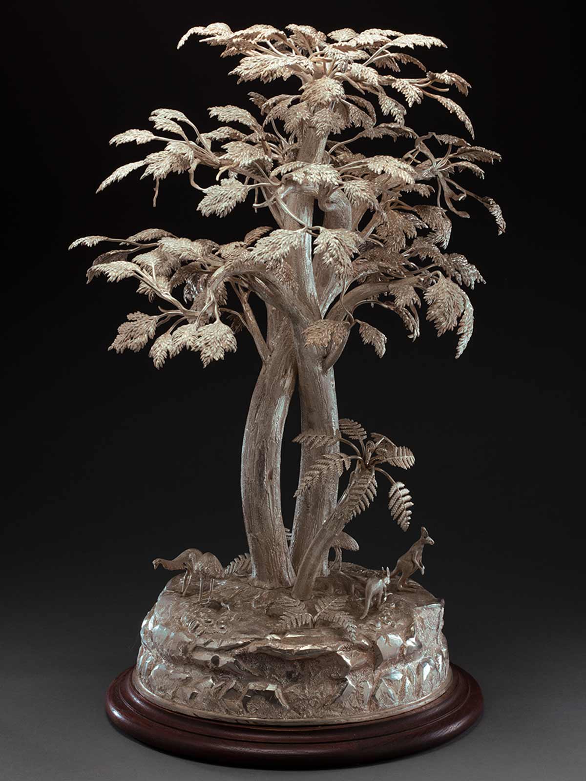 Silver tree with small silver kangaroos and emus on a round base. - click to view larger image
