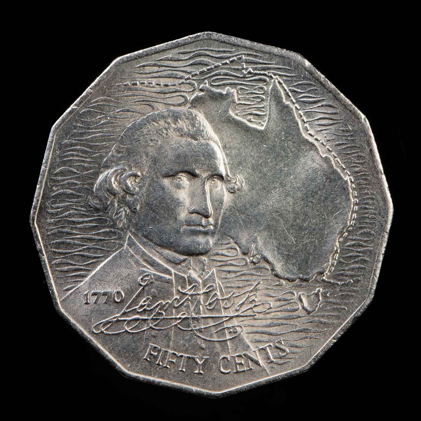 An Australian 50 cent coin with a picture of the map of Australia and the bust of Captain James Cook. The text '1770' then his signature and 'FIFTY CENTS' is located over the lower half of the bust. - click to view larger image