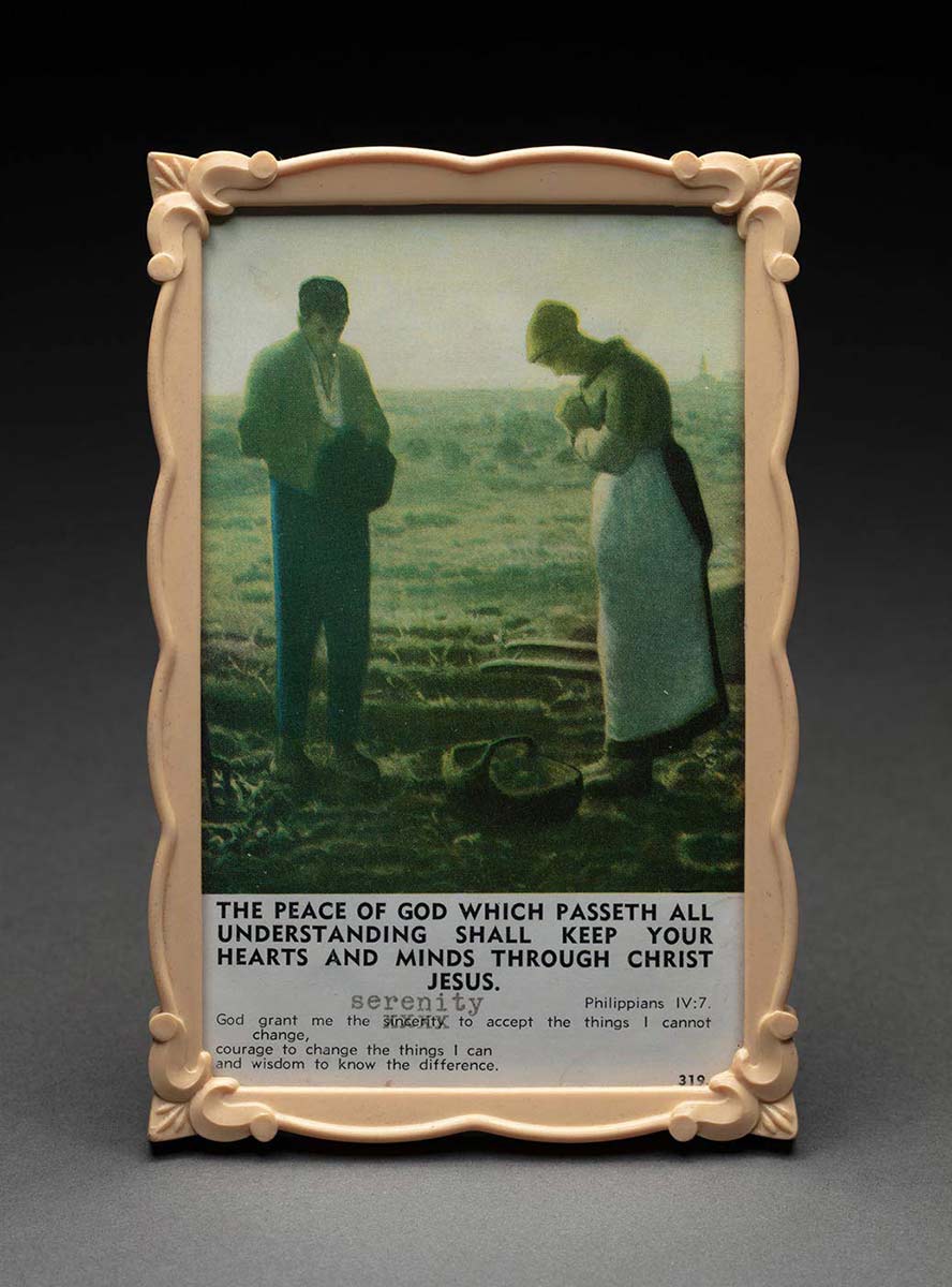Framed illustration of a sombre scene with a man and a woman wearing peasant clothing. Their heads are bowed and the woman is clasping her hands in the form of prayer. They both are looking down towards the ground which appears barren and features a basket. Below the illustration is the text: ‘THE PEACE OF GOD WHICH PASSETH ALL UNDERSTANDING SHALL KEEP YOUR HEARTS AND MINDS THROUGH CHRIST JESUS / PHILIPPIANS IV:7’. - click to view larger image