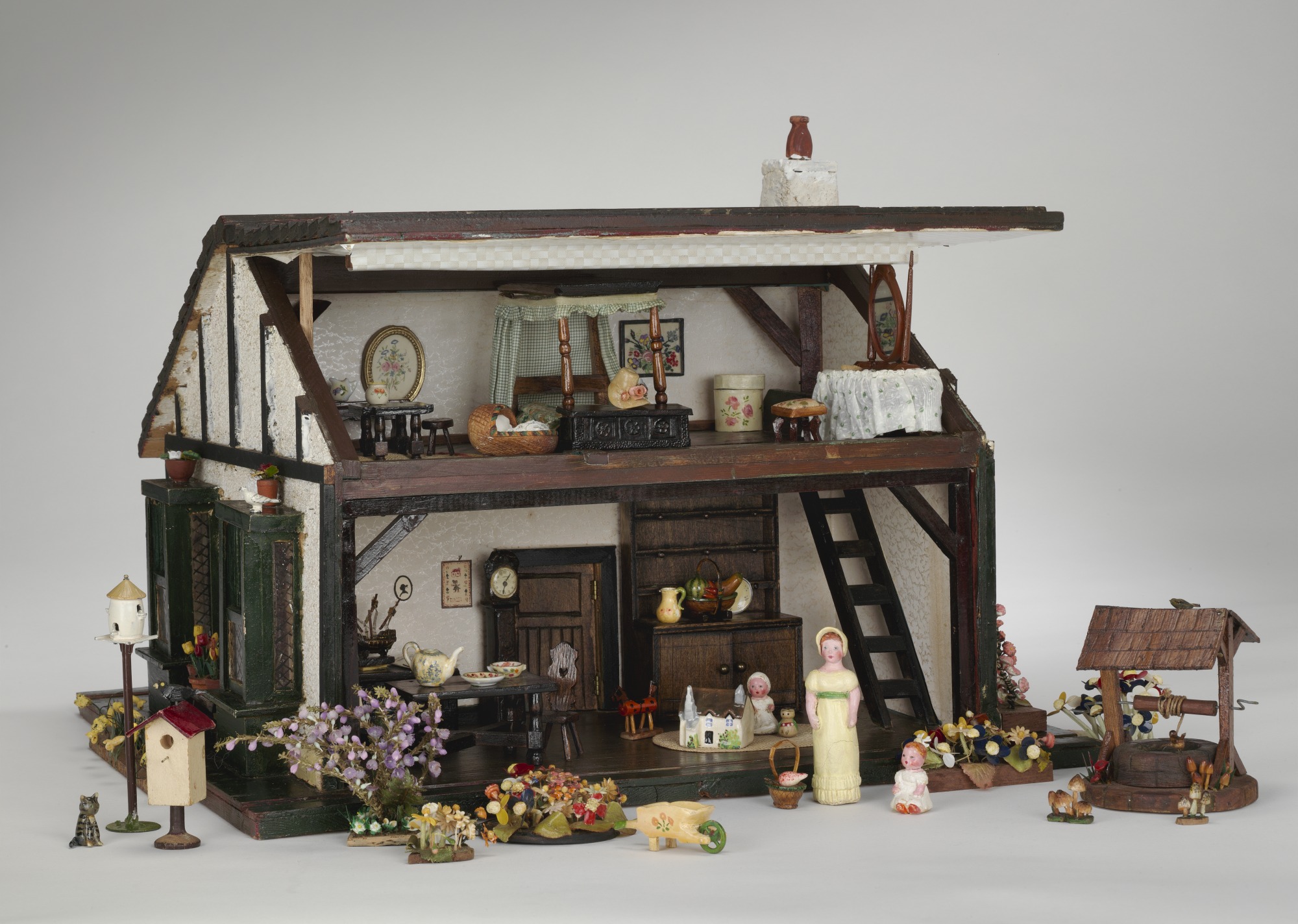A dollhouse with the roof lifted open to reveal its interior. - click to view larger image