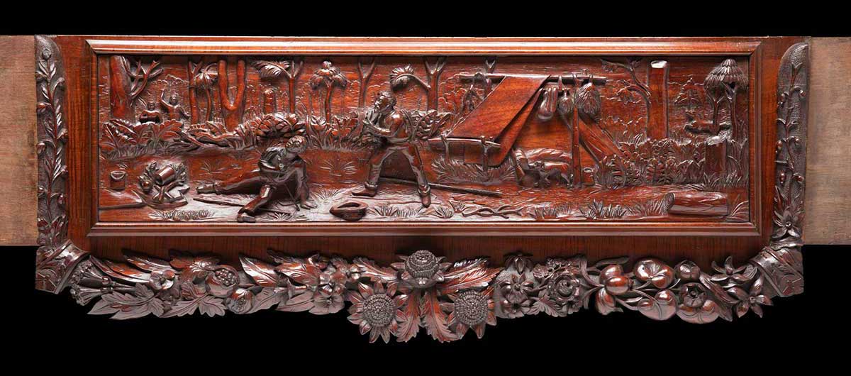 An ornate wooden panel with a relief carving of a scene with what appears to be two men under attack by two other men with spears.