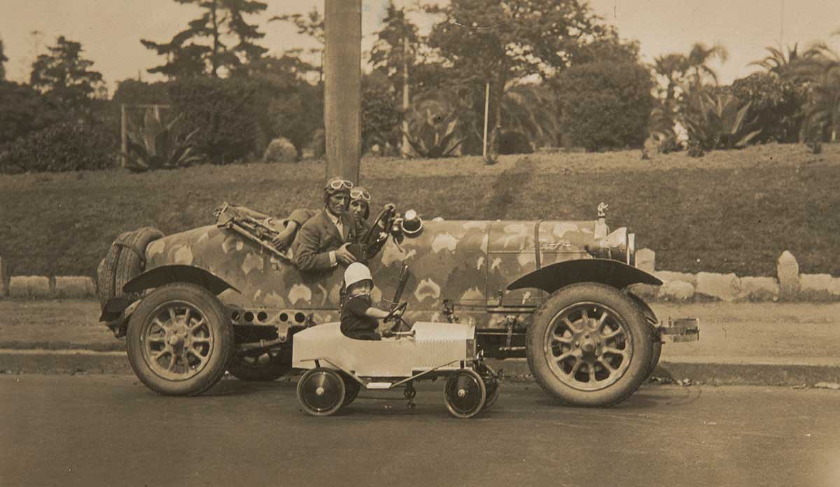 A black and white photograph featuring Francis Birtles and Alec (Alex) Barlow wearing driving caps and goggles and sitting in the Bean car. - click to view larger image