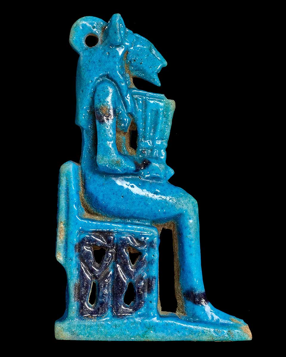 Blue ceramic sculpture of a human figure with the head of an animal.