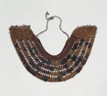 Horseshoe-shaped, collar-like breast ornament or gorget made of cane, coconut fibre, dog hair, shark teeth and feathers.