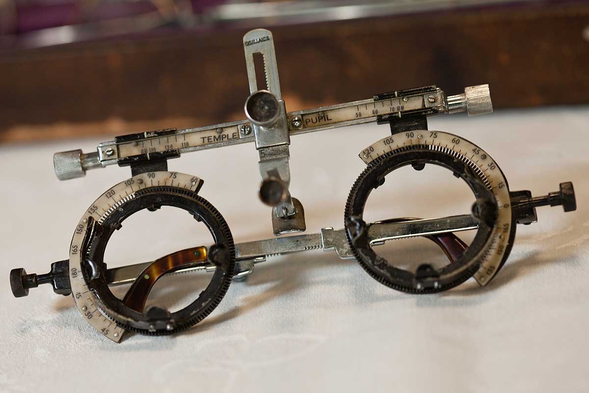 Heavy metal framed glasses,with an adjustable slide at top and a numeric scale on each side. - click to view larger image