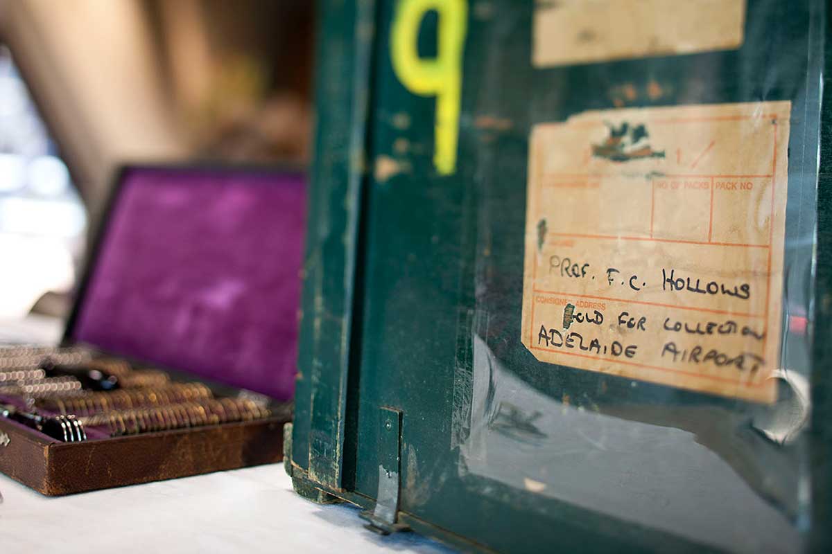 Close up image of an address label on the front of a green wooden storage box. - click to view larger image