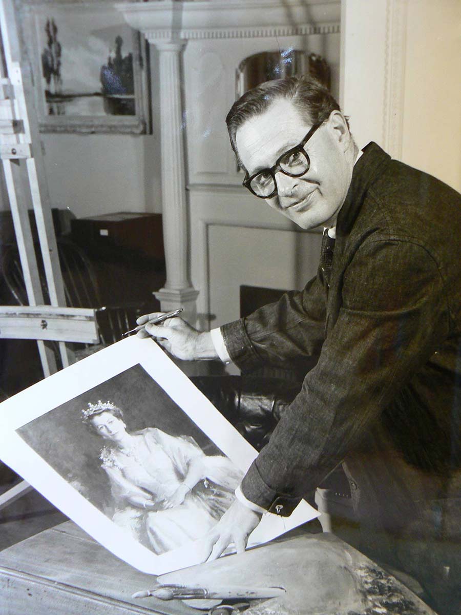 Black and white image of a man holding a copy of a portrait of Queen Elizabeth.