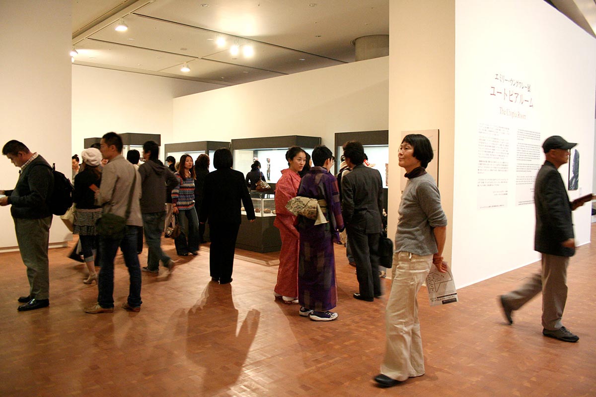 Visitors in an exhibition space viewing art works. - click to view larger image