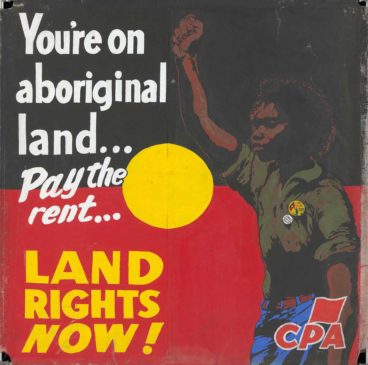 A protest banner hand painted on canvas, with the text 'You're on / aboriginal / land ... / Pay the rent ... / LAND RIGHTS NOW!'. An Aboriginal man stands to the right of the text with a raised fist. The background is the black, yellow and red of the Aboriginal flag, and a red 'CPA' logo is in the lower right corner. - click to view larger image