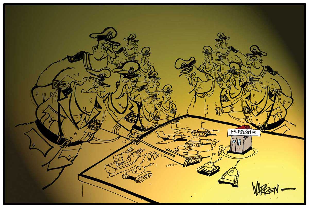 A colour cartoon depicting a group of high-ranking army officers gathered around a table. On the table are model tanks, aircraft and a gunboat, all arranged around a building marked 'Joel Fitzgibbon'. The officer in the foreground is pushing a tank forward with a pointer. - click to view larger image