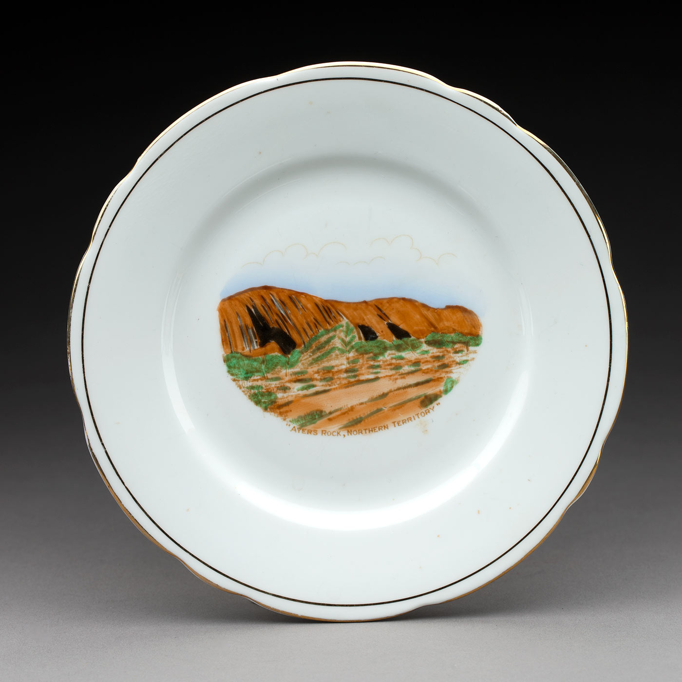 Painting of Uluru on a souvenir plate. - click to view larger image