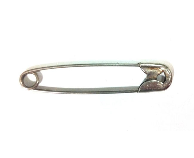 A close-up colour photo of a metal safety pin. - click to view larger image