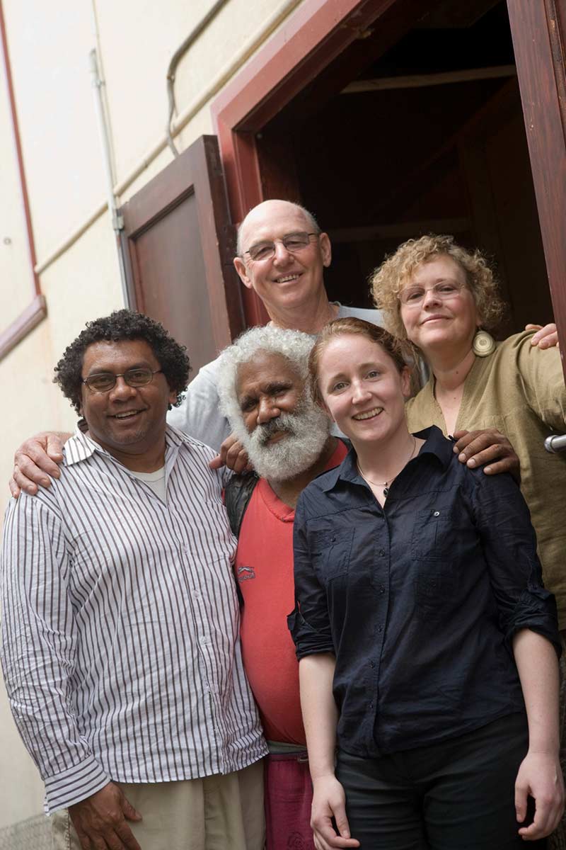 Group shot showing five people standing outside a doorway. - click to view larger image