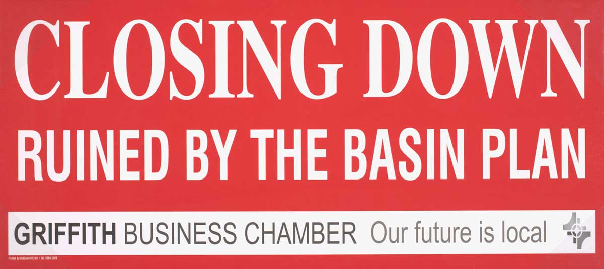 Placard with red background with the text ‘CLOSING DOWN / RUINED BY THE BASIN PLAN / GRIFFITH BUSINESS CHAMBER / Our future is local’.