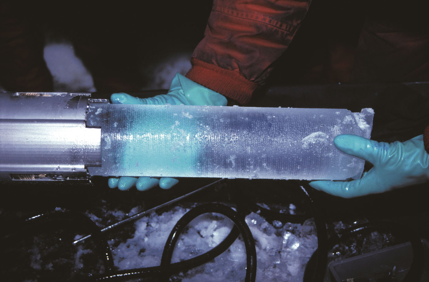 Pair of hands holding an ice core. - click to view larger image