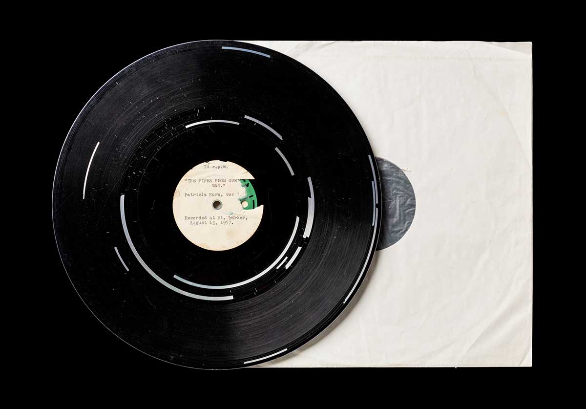 An audio record accompanied by a white paper slip cover. The title is 'The Piper from Over the Way' with vocals by Patricia Hurn. - click to view larger image