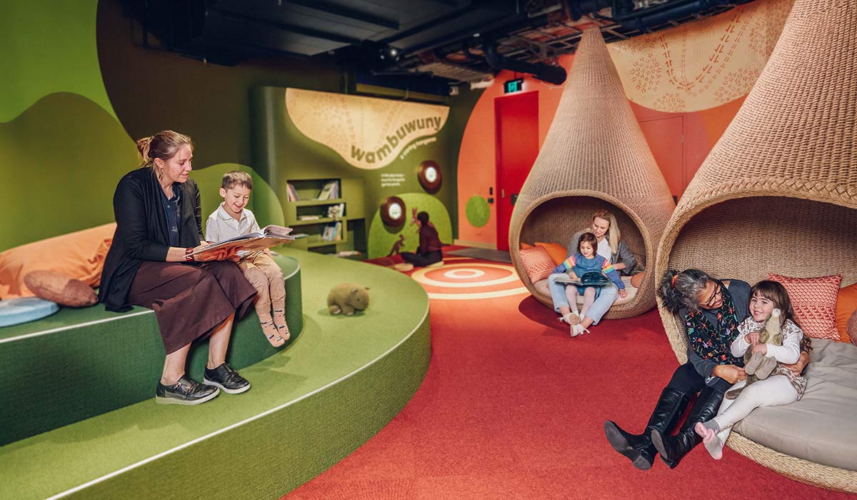 Promotional image of a colourful play space with children and adults.