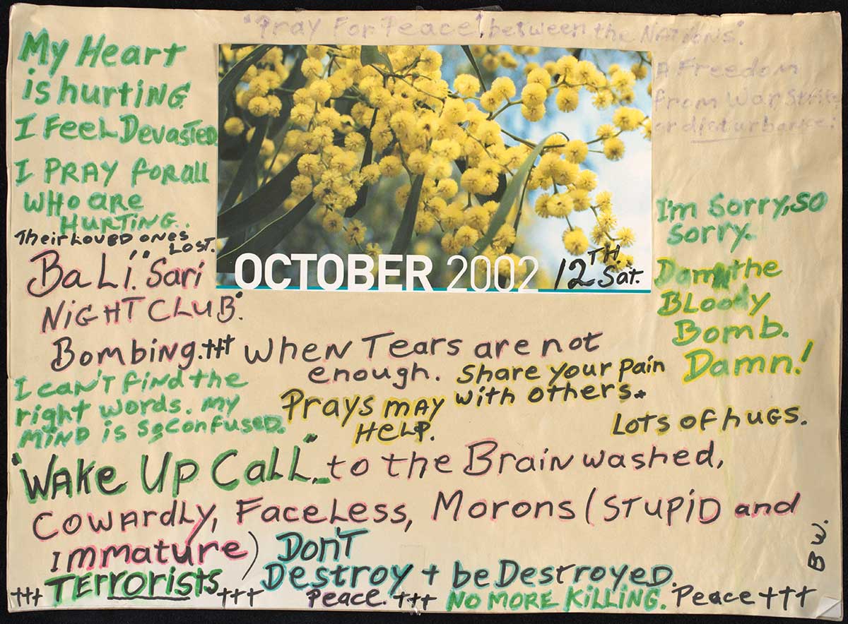 A card filled with hand-written messages of condolence. In the centre top section is an image of blossoms and the text 'OCTOBER 2002 / 12th Sat.' - click to view larger image