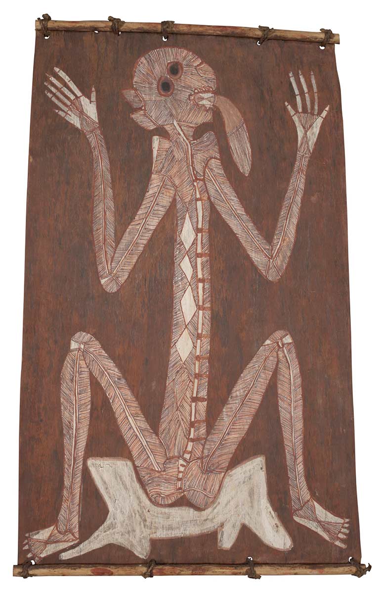 A bark painting worked in ochres on bark and on wooden restrainers. It depicts a spirit figure seated on a white tree stump. The spirit figure is painted with a white background and red ochre and charcoal crosshatching. There are four white diamond shapes on the body. - click to view larger image