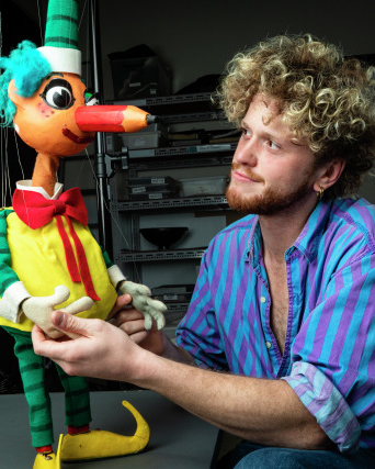 A photograph of Tom Hetherington with Mr Squiggle.