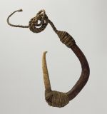 Fishhook with curved wooden shank, bone point, and lashing of twisted cords of plant material.