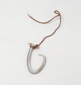 Fishhook made of mother-of-pearl, where strings made of various plant fibres are attached.