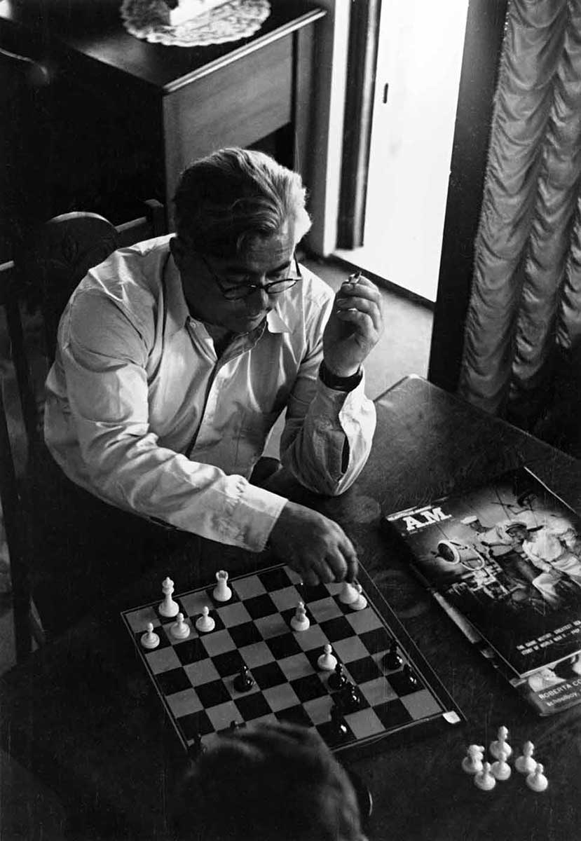 Man in shirt sleeves playing chess. - click to view larger image