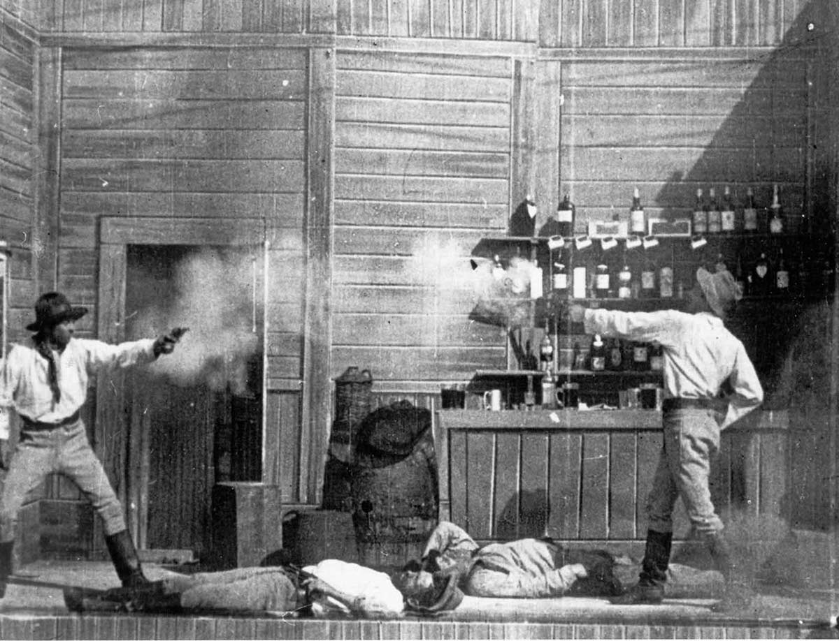 A shooting duel scene from an old black and white movie.