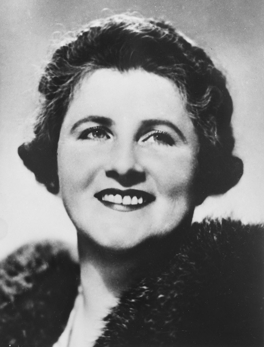 Black and white photo of smiling Dame Enid.