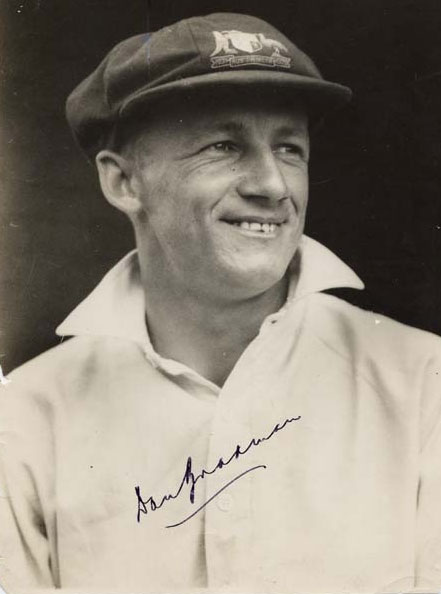 Portrait photo of Donald Bradman smiling, photo signed by him. - click to view larger image