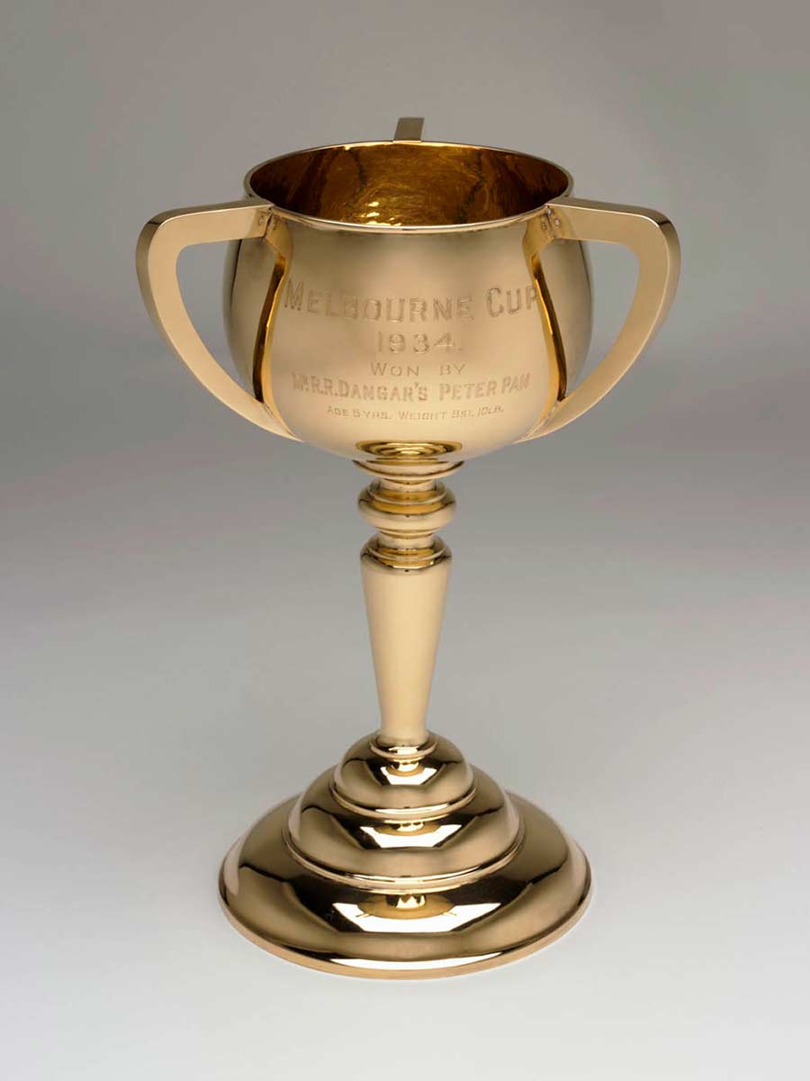 Three-handled gold cup engraved with 'MELBOURNE CUP, 1934, won by Mr RR Dangar's Peter Pan, age 5 yrs. Weight 8st 10lb'. - click to view larger image