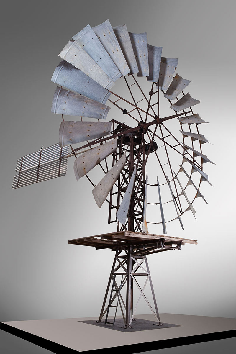 A photo of the top section of a windmill on display indoors - click to view larger image