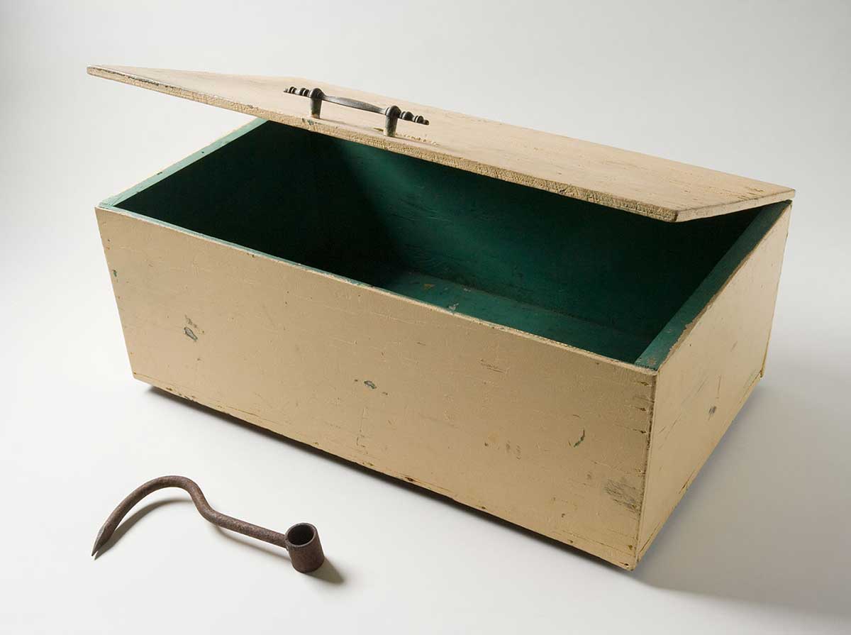 A rectangular yellow tuckerbox box painted green inside and a rusted hook. - click to view larger image