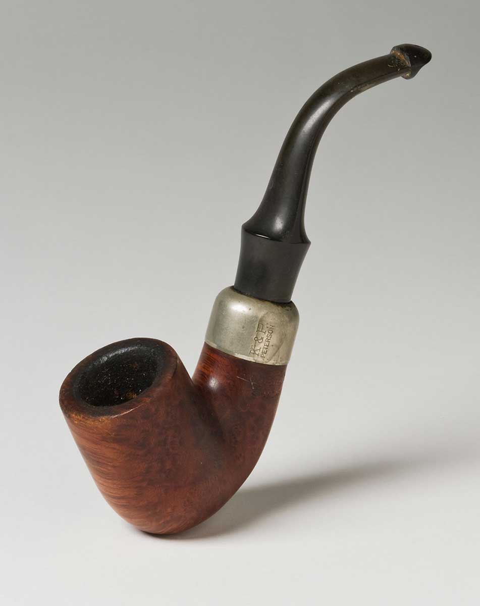 A J shaped, curved tobacco pipe with a brown Briarwood bowl, nickel cap and and a black mouthpiece. - click to view larger image