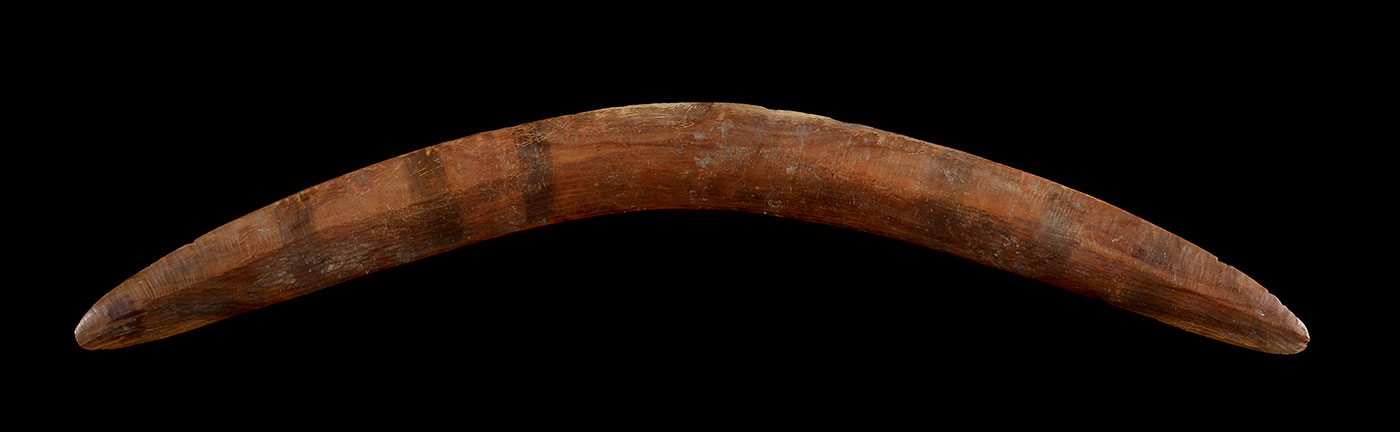 Curved wooden boomerang.